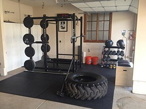 Cool Strength Training Gym With A Trailer Tire For Crossfit Exercises And Free Weights On A Power Rack