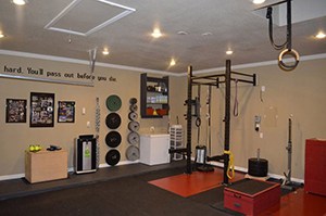 Garage Gym Ideas Don't Get Any Better Than This Quote Inspired Brown Theme Garage Gym With Weights On Walls And A Power Rack