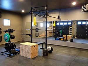 Gym Mirror Combined With A Homemade Garage Gym. Complete With A Freeweights Rack, Jump Box, And Pullup Bars For Working Out.