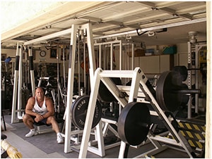 Monster Garage Gym Built With Heavy Lifting And Strength Training In Mind. Pec Dec Machine And Cable And Pulleys In The Background.