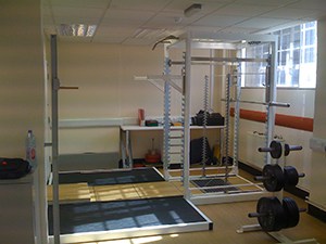 Very Cool Looking And Perfectly Laid Out Garage Gym With A Huge Power Rack And Free Weights. Squats On Squats On Squats.